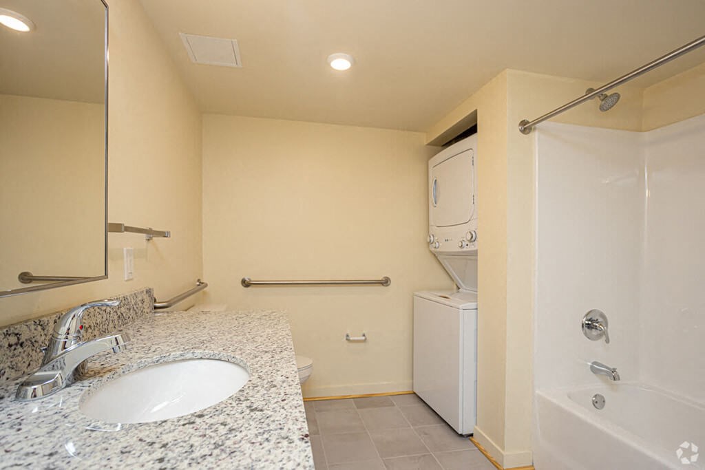 a bathroom with a sink and a shower and a toilet