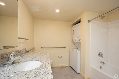 a bathroom with a sink and a shower and a toilet