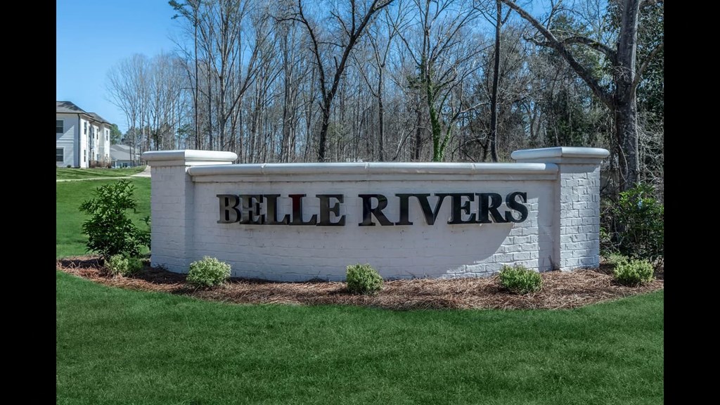 a sign in front of trees
