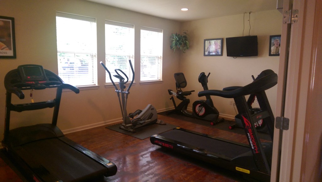a home gym with exercise equipment in a living room