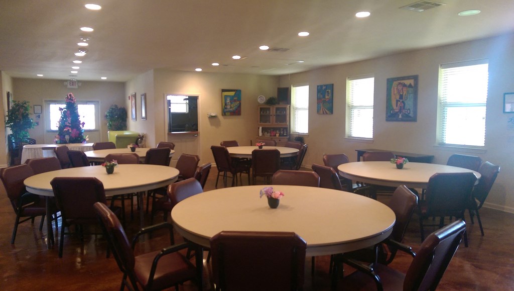 a dining room with round tables and chairs