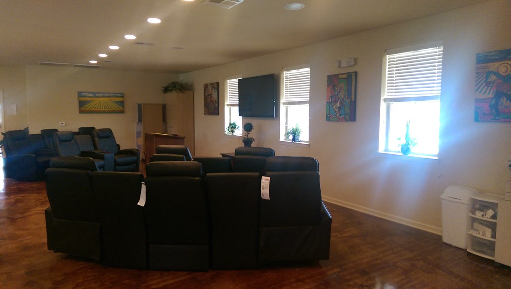 a conference room with a bunch of black couches and chairs
