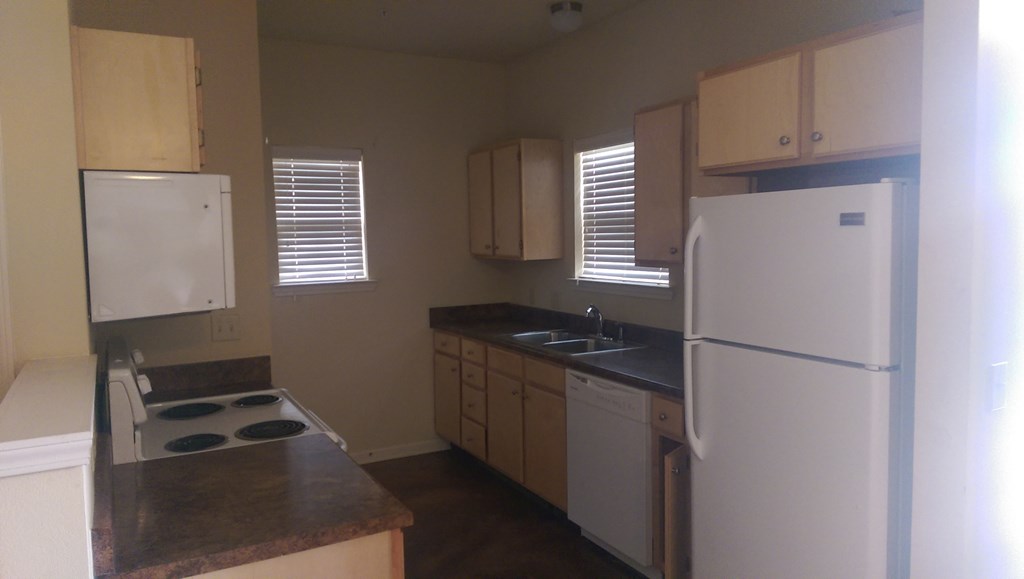 a kitchen with white appliances and white cabinets