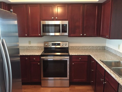 A kitchen with a stove top oven and microwave above it.