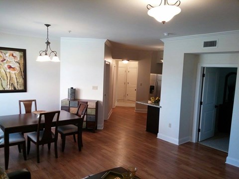 A dining room with a wooden table and chairs.