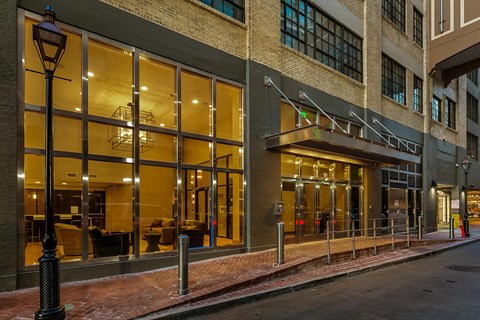 A building with a glass facade and a black lamp post in front.