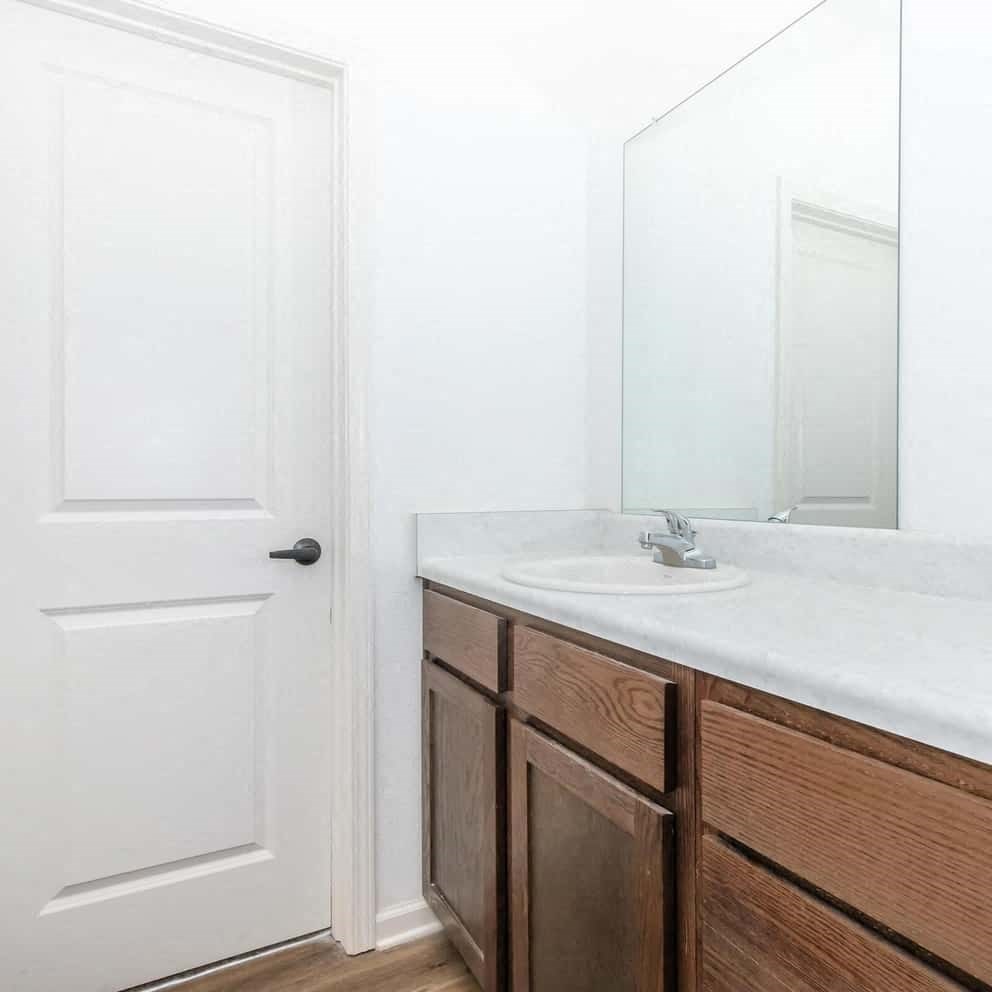 a room with a mirror and a wood floor