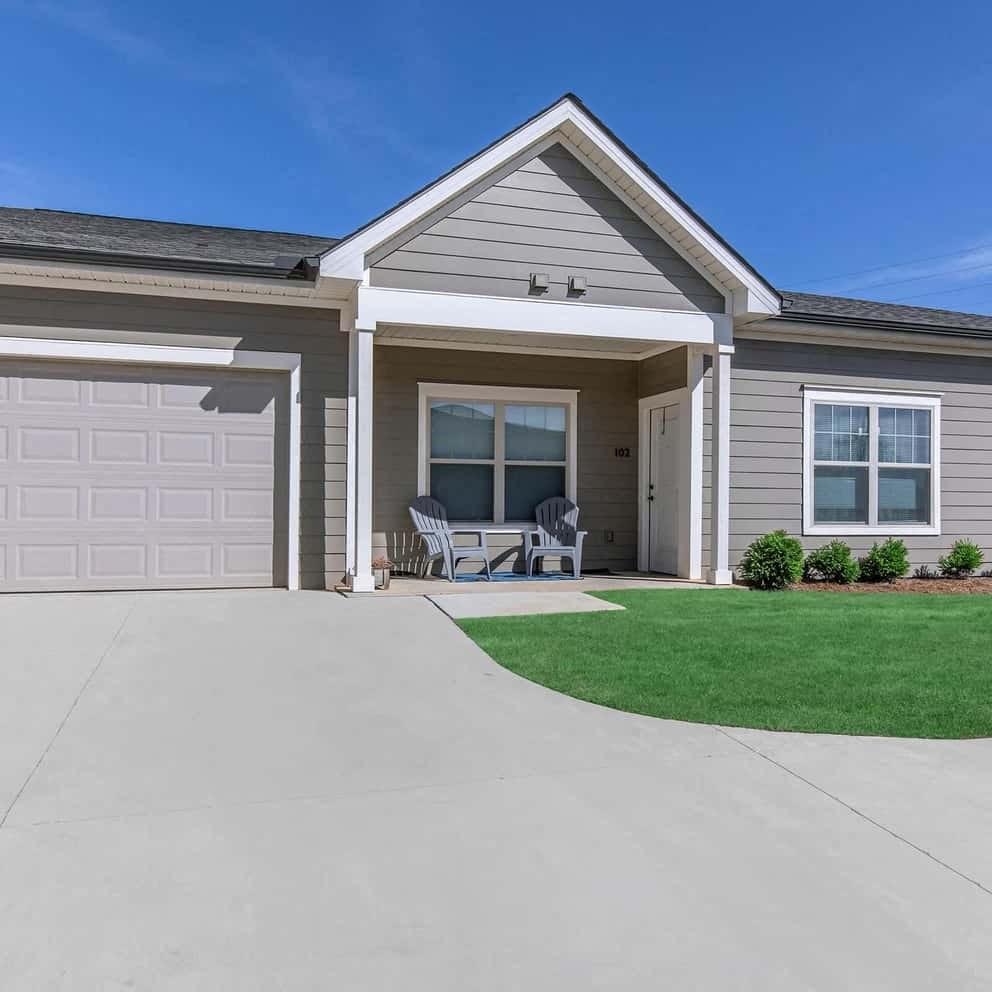 the front of a house with a driveway and a garage door