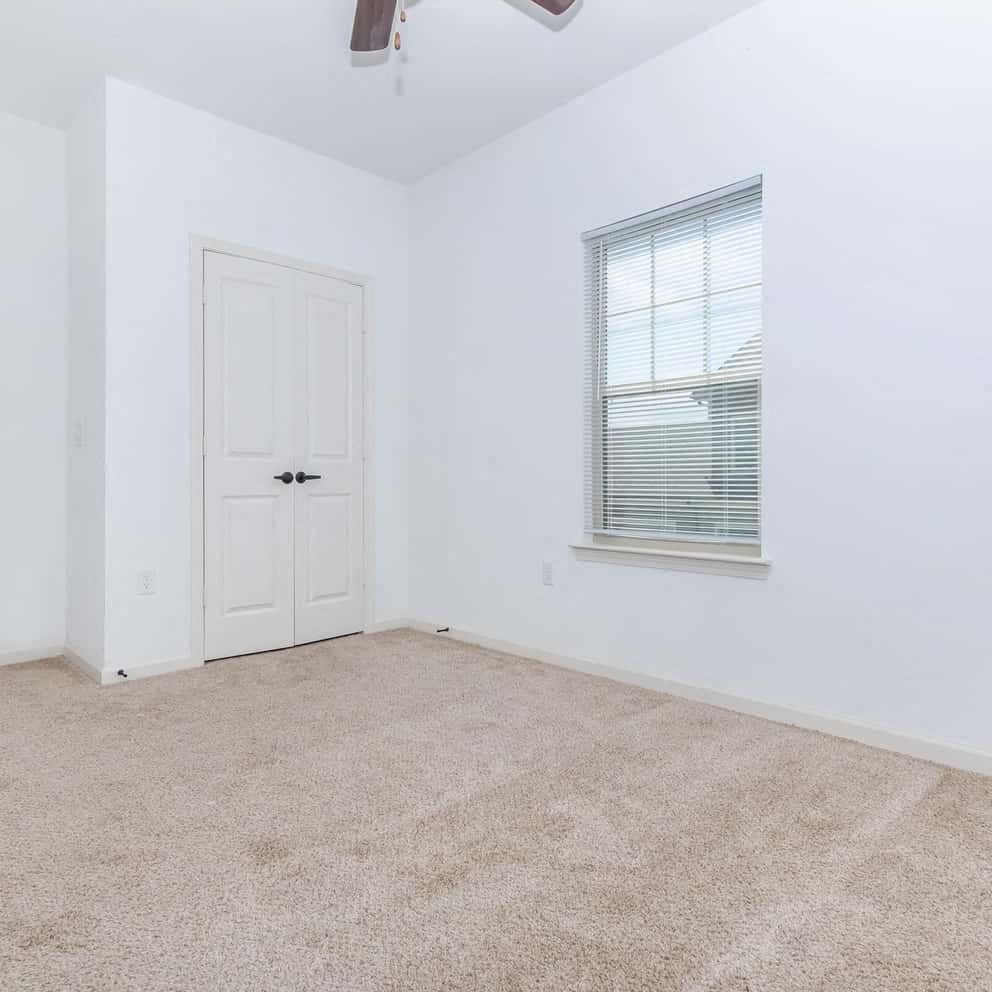 an empty room with white walls and a window
