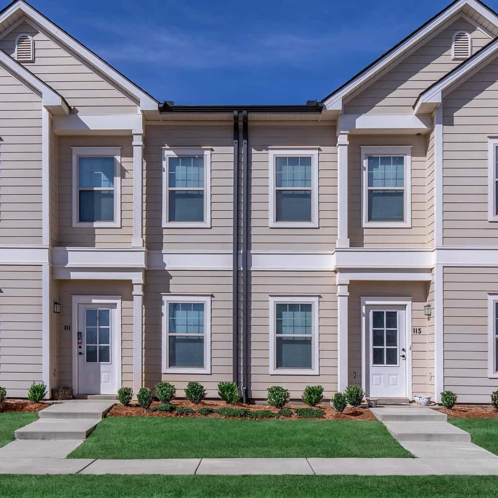 a white house with a lawn in front of it