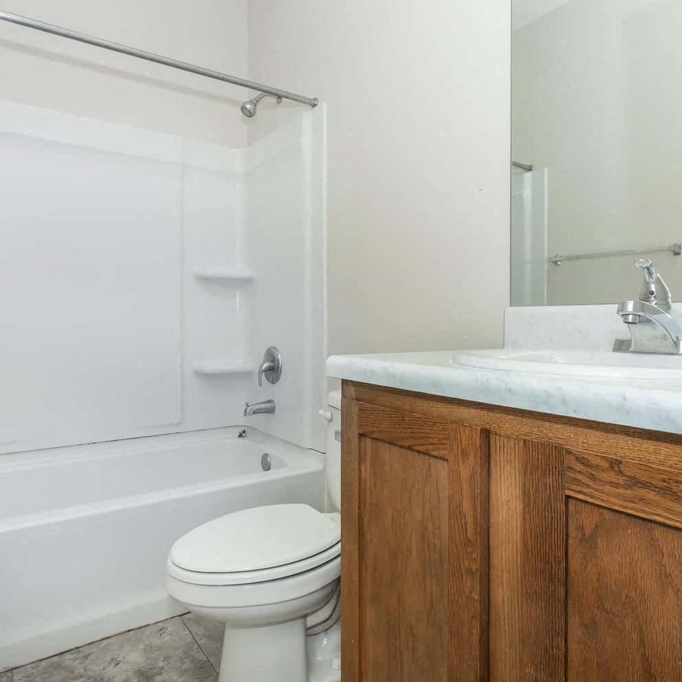 a bathroom with a toilet and a sink and a shower