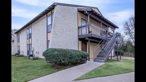 A two-story building with a balcony on the second floor.