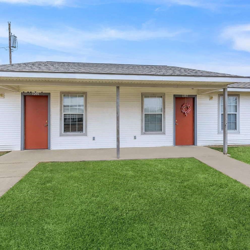 A white house with red doors and windows.