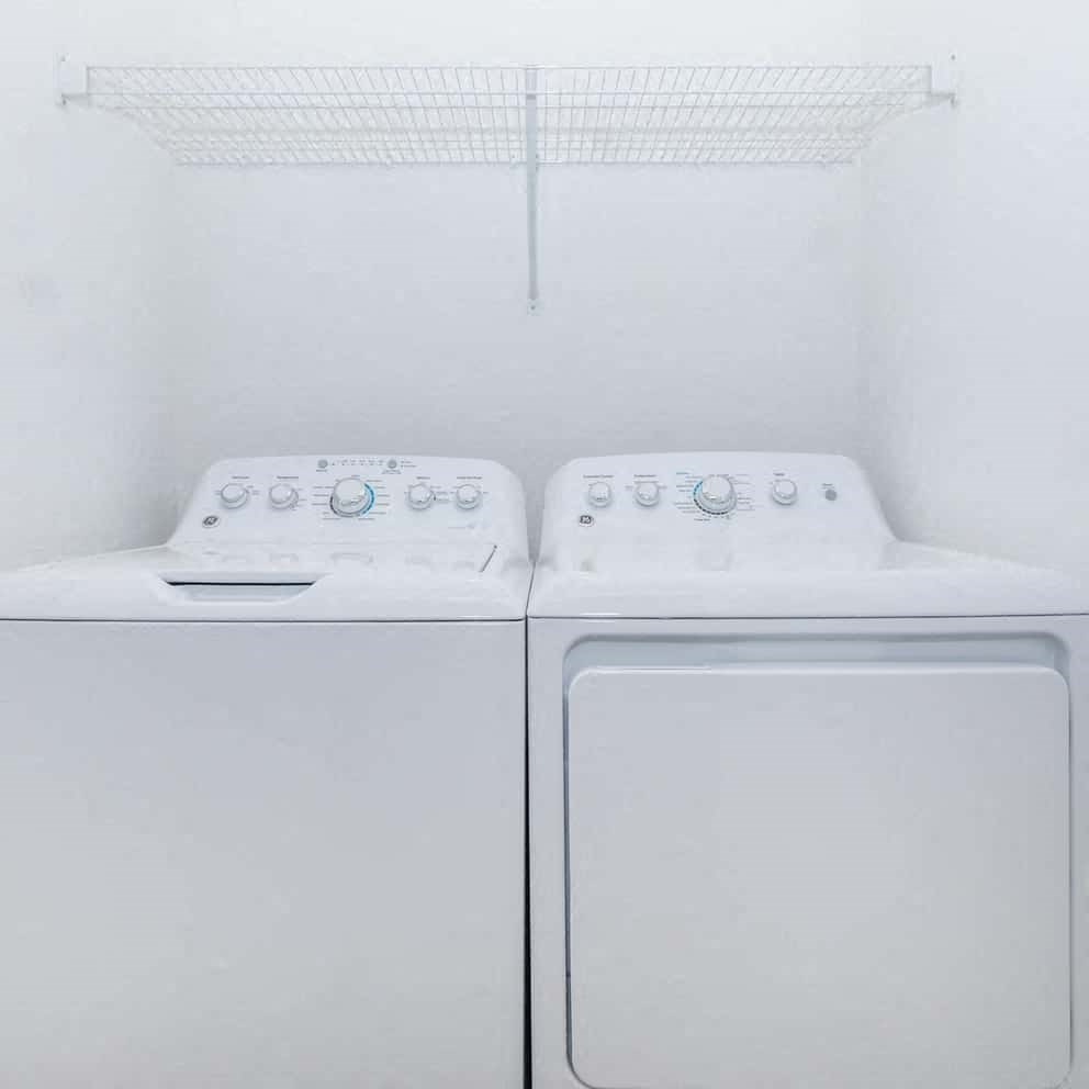 a close up of a bed with white sheets and pillows