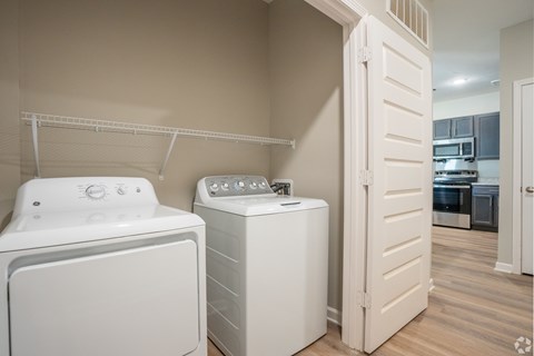 A white dryer and washer are in a laundry room.