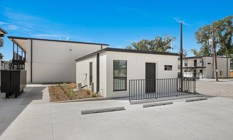A modern building with a black fence in front.