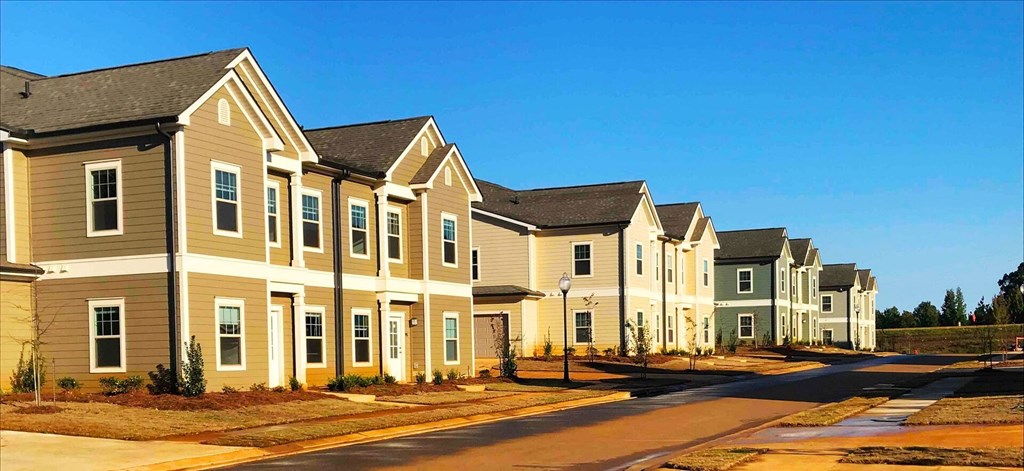 a row of town houses on the side of a street