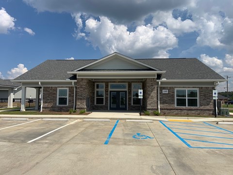 A building with a parking lot in front of it.
