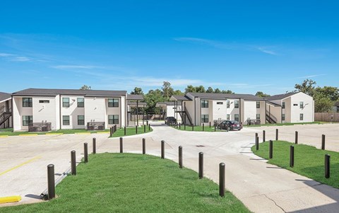 A row of houses with a grassy area in front.