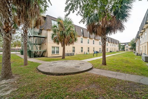 A large building with a green lawn in front of it.