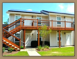 A house with a staircase leading to a deck.