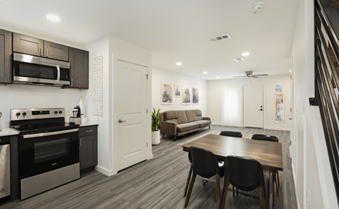 A modern kitchen with a dining table and chairs.