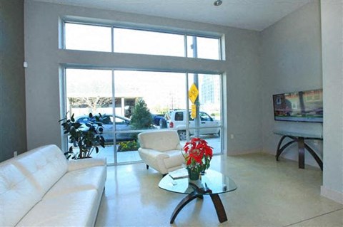 a living room with a white couch and a glass table