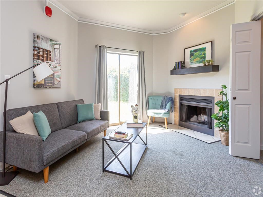 a living room with a couch and a fireplace