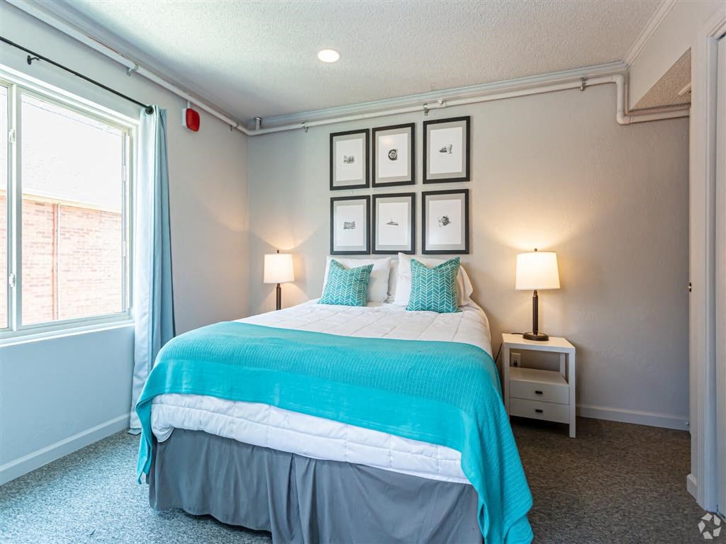 a bedroom with a bed and a window