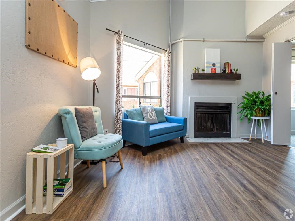 a living room with blue furniture and a fireplace