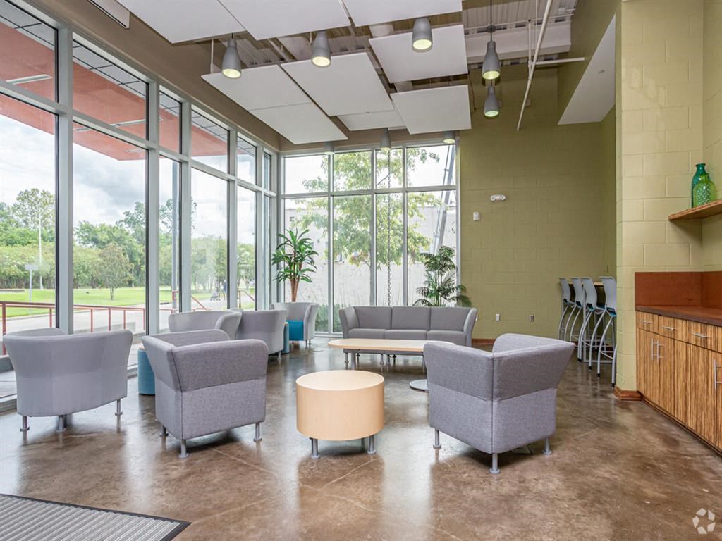 a lobby with couches and chairs and large windows