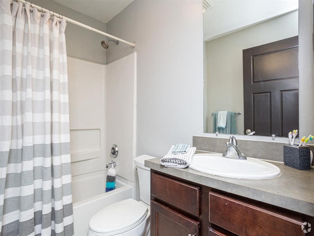 a bathroom with a sink toilet and a mirror
