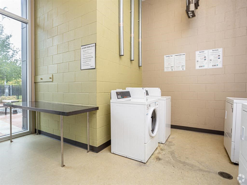 a laundry room with a washing machine and a table
