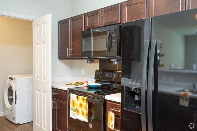 a kitchen with black appliances and a black refrigerator