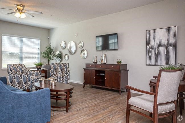 a living room with a couch and chairs and a table