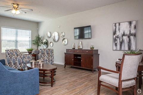 a living room with a couch and chairs and a table