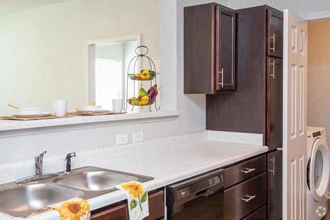 a kitchen with a sink and a refrigerator