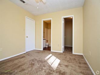 an empty room with two doors and a bathroom in the background - Photo Gallery