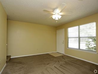 an empty room with a ceiling fan and a window - Photo Gallery 1