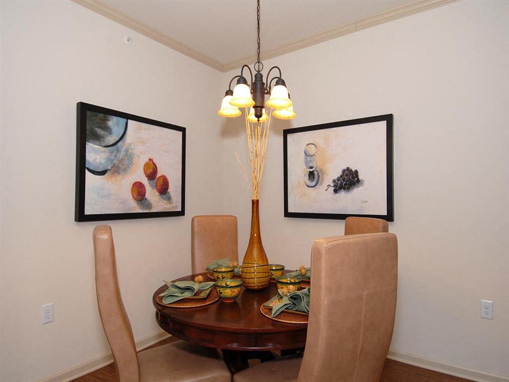 a dining room with a table and chairs and a chandelier