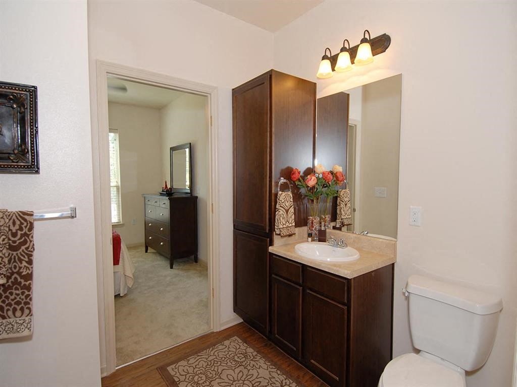 a bathroom with a toilet sink and a mirror