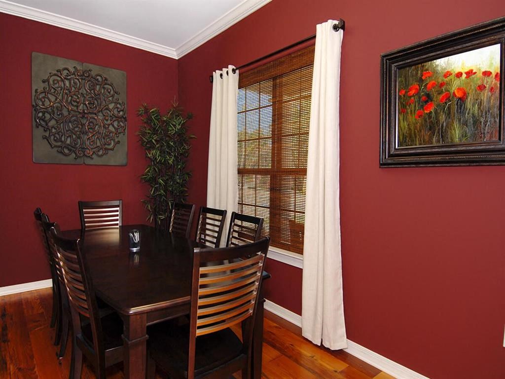 a dining room with a wooden table and chairs