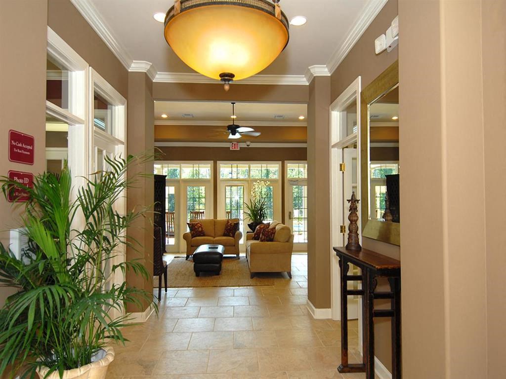 a lobby with a couch and chairs and a ceiling fan