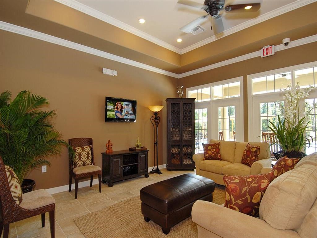 a living room with furniture and a ceiling fan