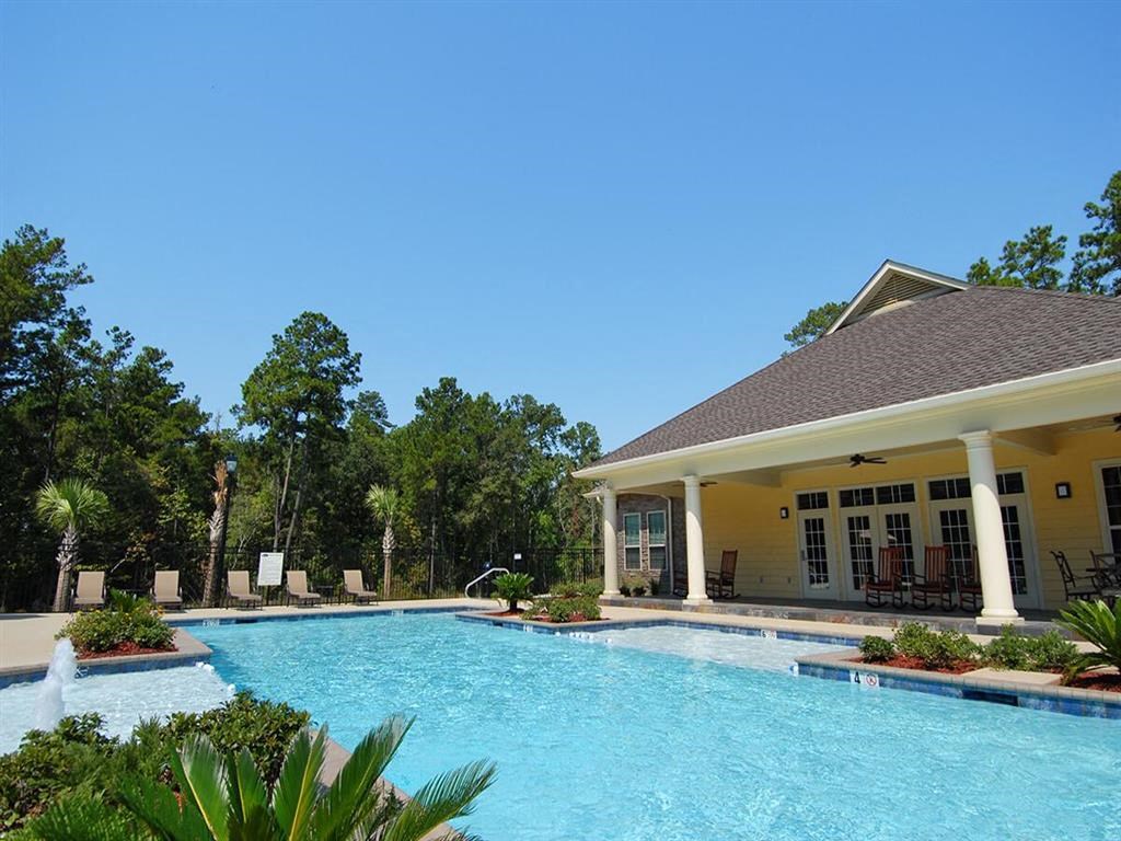 a large swimming pool in front of a house