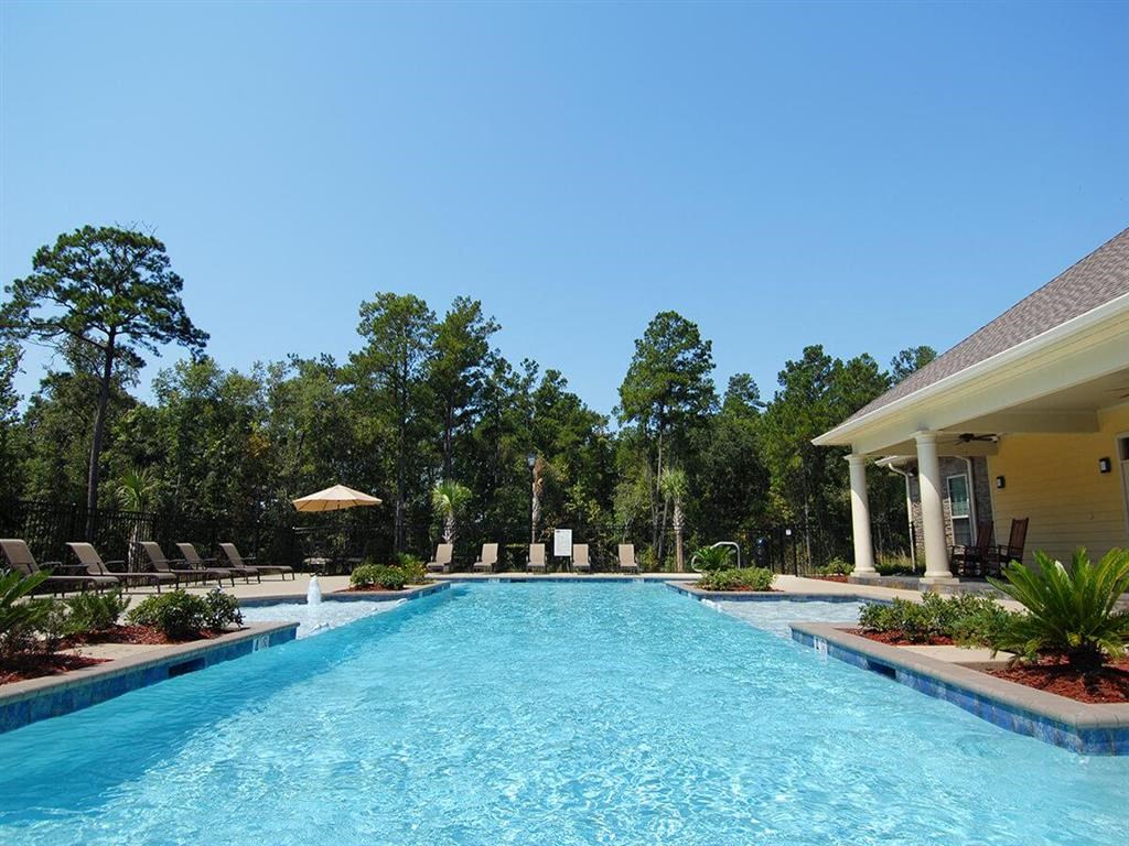 a large swimming pool in front of a house