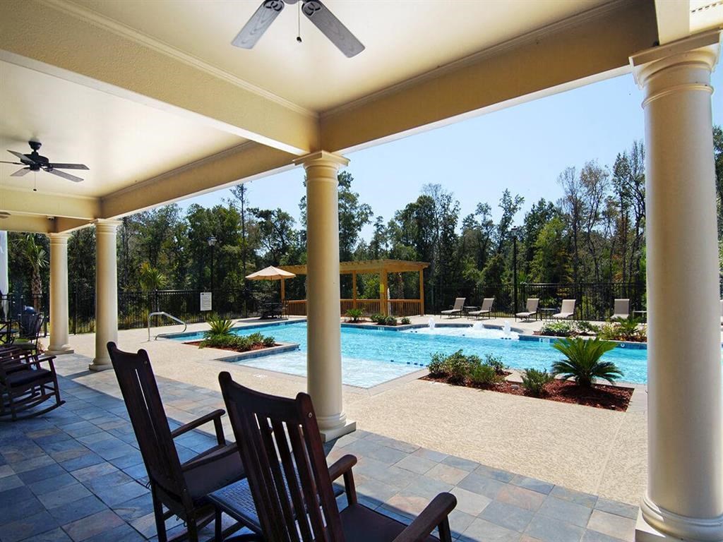a patio with chairs and a swimming pool
