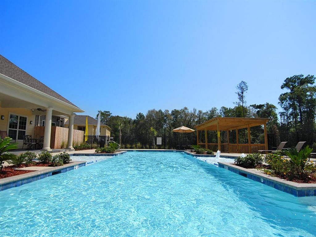a large swimming pool in front of a house
