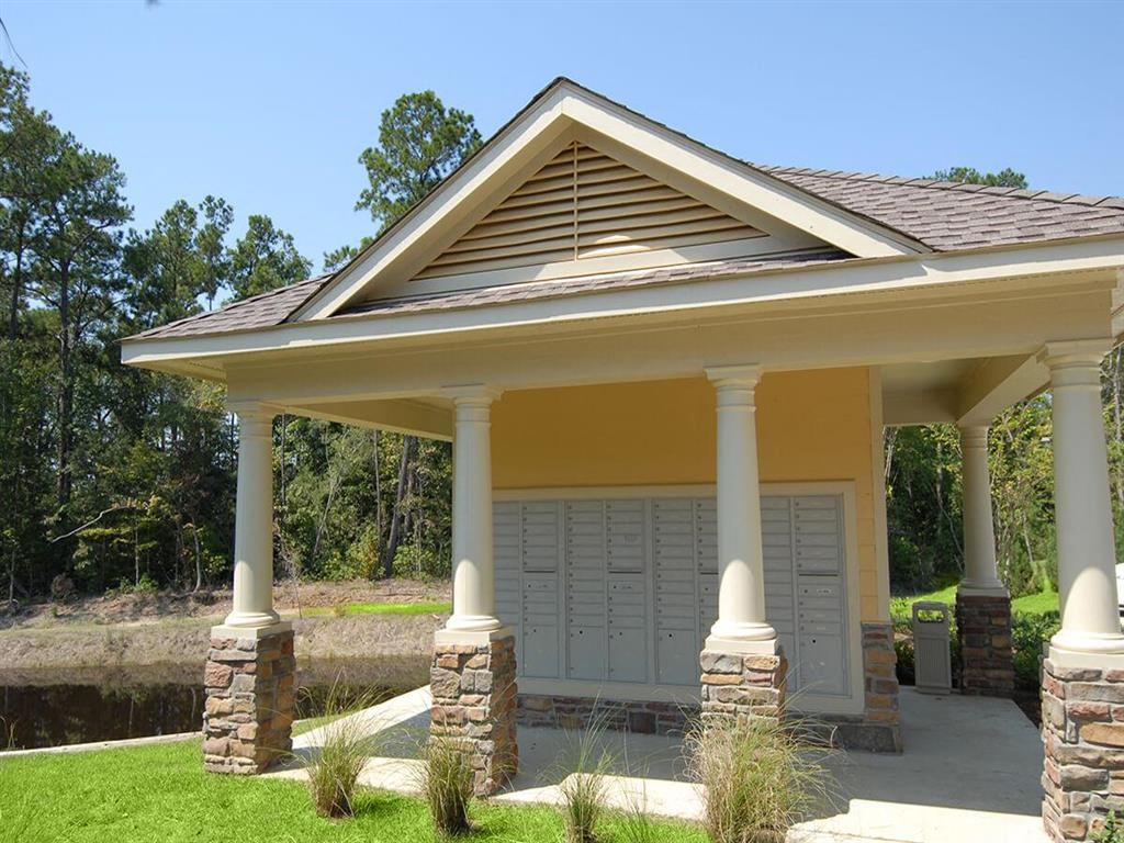 a covered porch with columns and a garage door