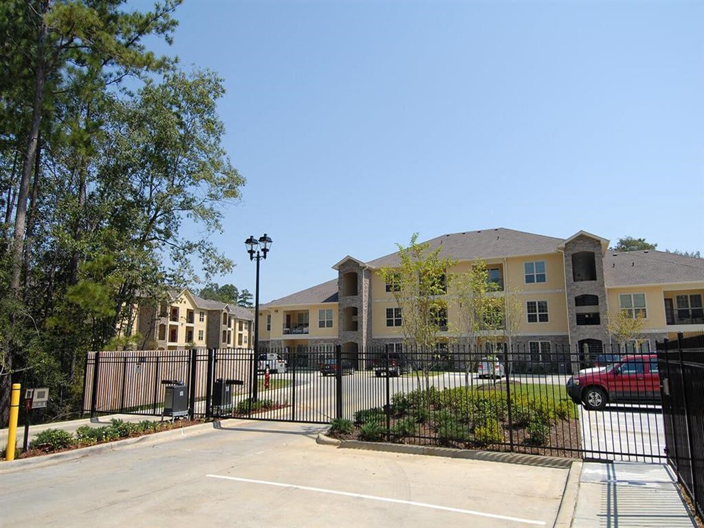 an empty parking lot in front of an apartment building